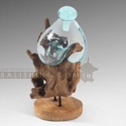Balishine: Your natural source of indonesian handicraft presents in its Home Decor collection the Handmade Blown Glass 1 bottle with Teak Wood Stand:12INT878051:Beautiful root teak wood is reminiscent of jagged rocks, while the clear handblown crystal takes on the nature of the tides for an eye-catching decorative piece that is the perfect addition to your home.  This piece include 1 pc bottle made from handmade blowing glass diameter 20 cm with glass stopper. Because each bottle is handmade, shape and size can vary slightly and tiny bubbles may appear within the glass. This exemplifies the hand-blown technique, making every piece a unique example of blown glass craftsmanship.