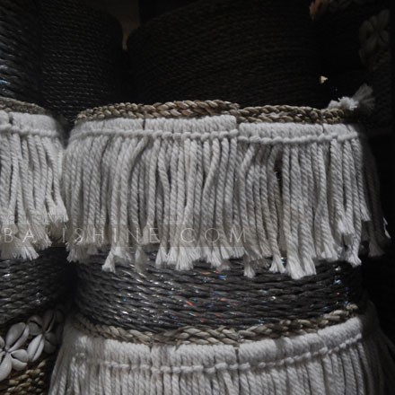 Balishine: Your natural source of indonesian handicraft presents in its Home Decor collection the Round Seagrass Tassel Fringe Basket:12JEN368093:Putting a unique twist on everyday essentials, this silver coloured seagrass basket will make a charming addition to your living space. Cream fringe detailing adds a boho chic finishing touch.  Set of 3 pcs stackable. Other size and colors possible. Please contact us.